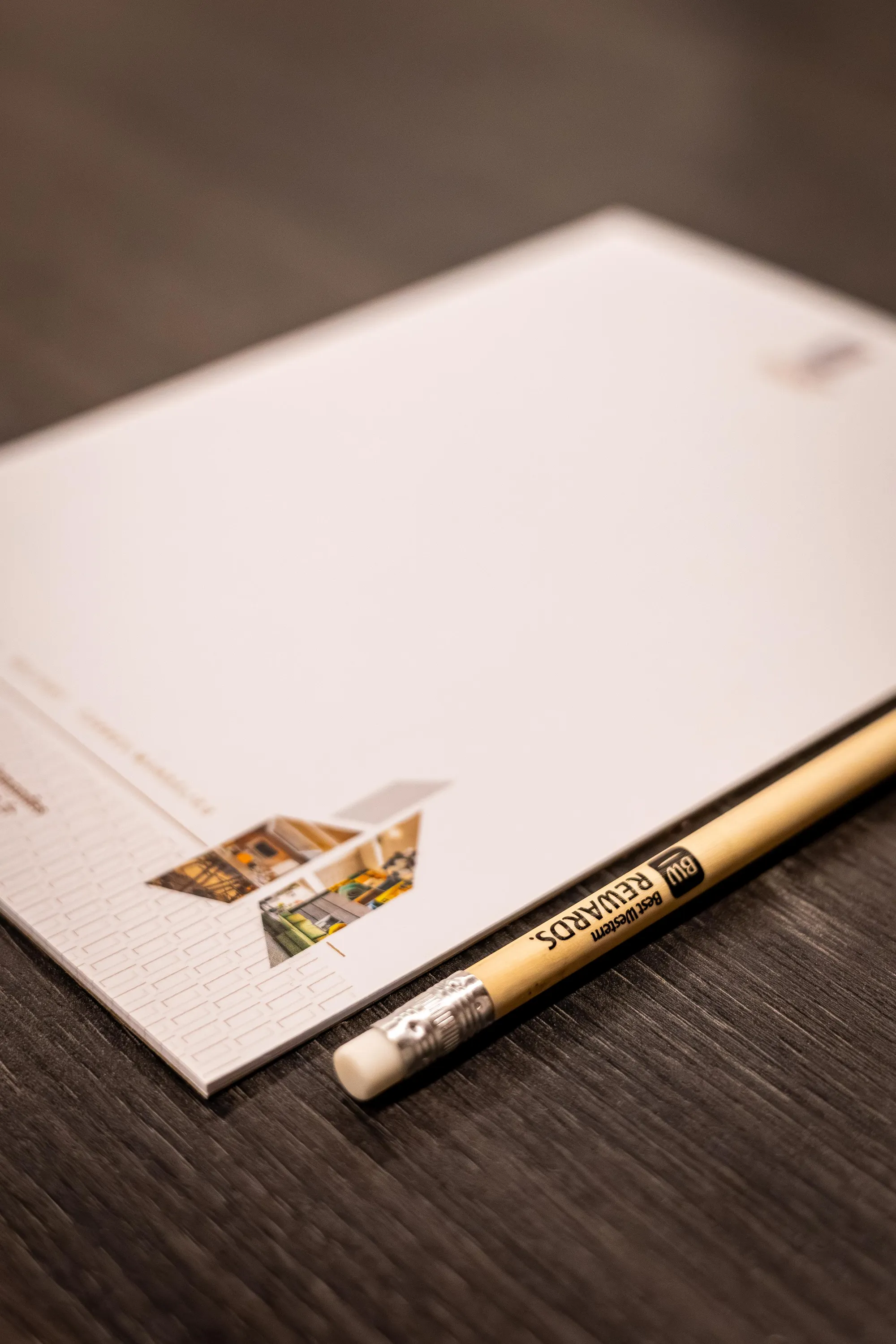 A pencil placed on a sheet of drawing paper with a partial sketch